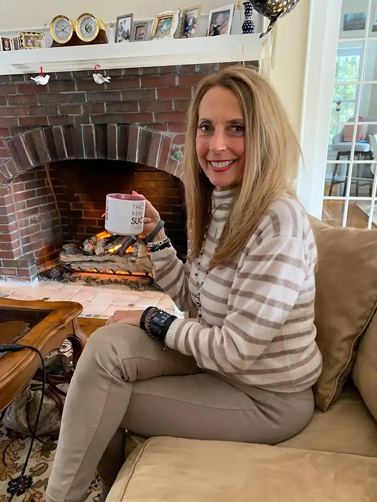 Anna Sabatino, sitting on couch drinking tea 